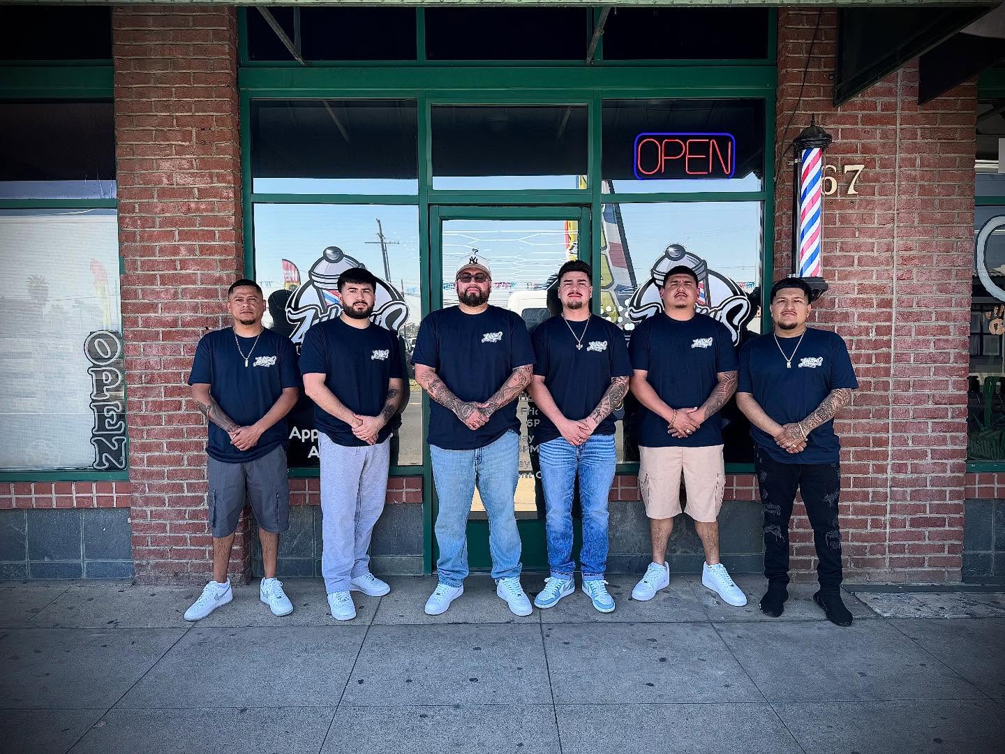 The Ambitious Barber Studio team outside the shop on South Main Street