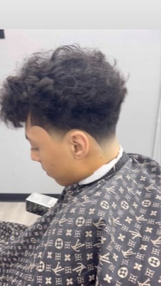 Textured curly top with taper