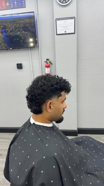 Curly fade with razor detail